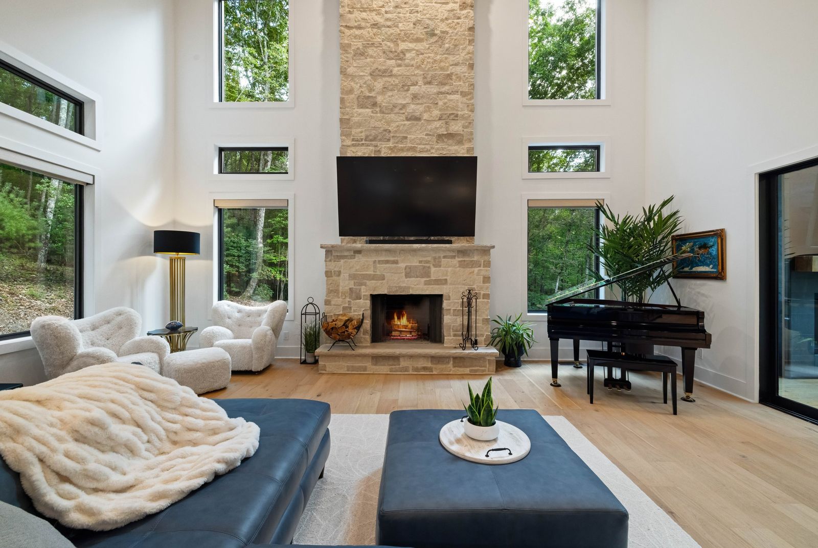 Great room with stone fireplace and walls of glass